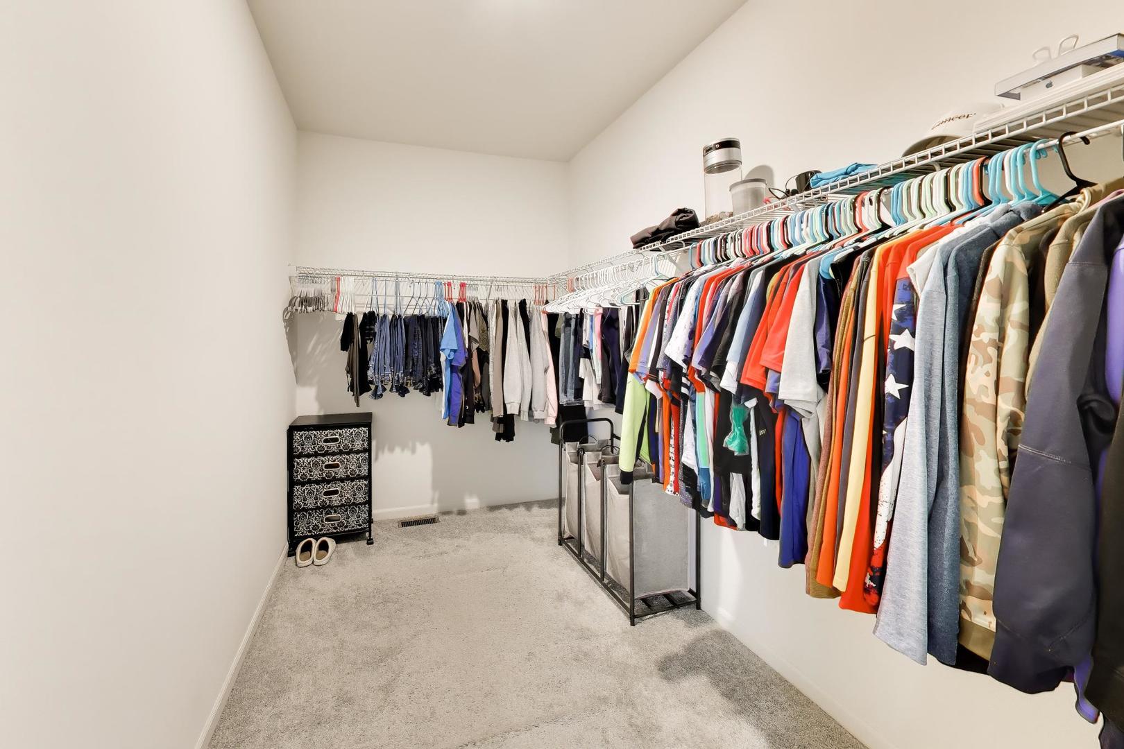 14831 Whitney Street Manhattan, IL 60442 - Photo 19 of 37 a view of walk in closet with clothes and shoes