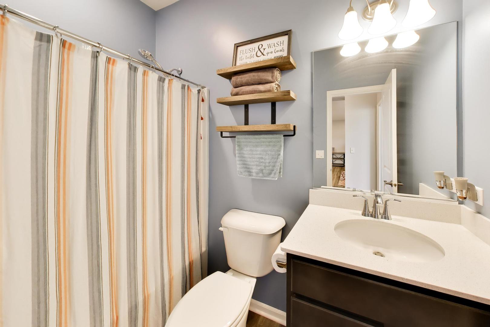 14831 Whitney Street Manhattan, IL 60442 - Photo 25 of 37 a bathroom with a sink a toilet and shower curtain