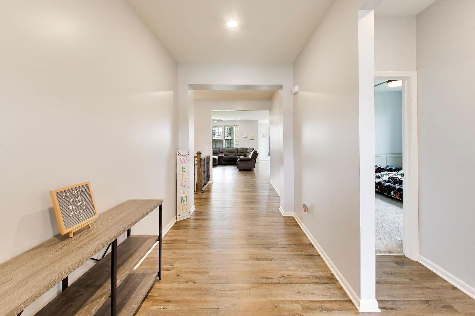 14831 Whitney Street Manhattan, IL 60442 - Photo 3 of 37 a view of a hallway with wooden floor and furniture