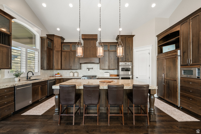 1205 North Elk Rdg Lane, Unit 202 Alpine, UT 84004 - Photo 20 of 88 Spacious kitchen featuring an expansive center island with seating, a built-in range, stainless steel appliances, and abundant wood cabinetry