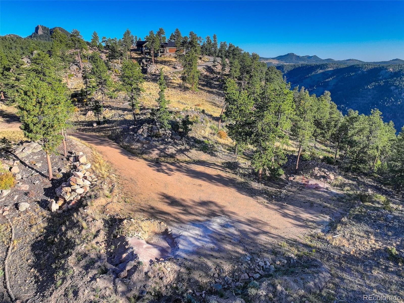 23047 Big Game Trail Conifer, CO 80433 - Photo 18 of 41 a view of a forest with trees in the background
