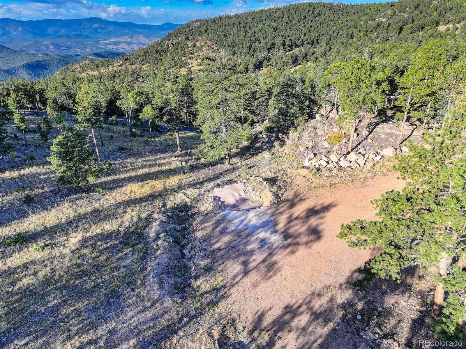 23047 Big Game Trail Conifer, CO 80433 - Photo 19 of 41 a view of a yard with wooden fence