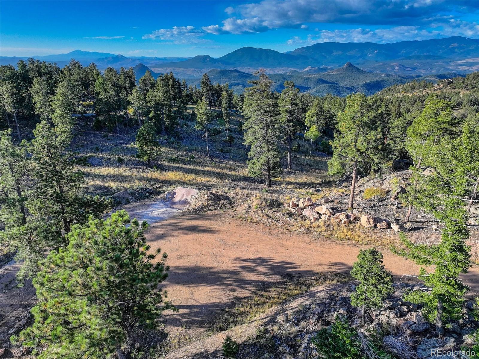 23047 Big Game Trail Conifer, CO 80433 - Photo 3 of 41 a view of a yard with a wooden fence