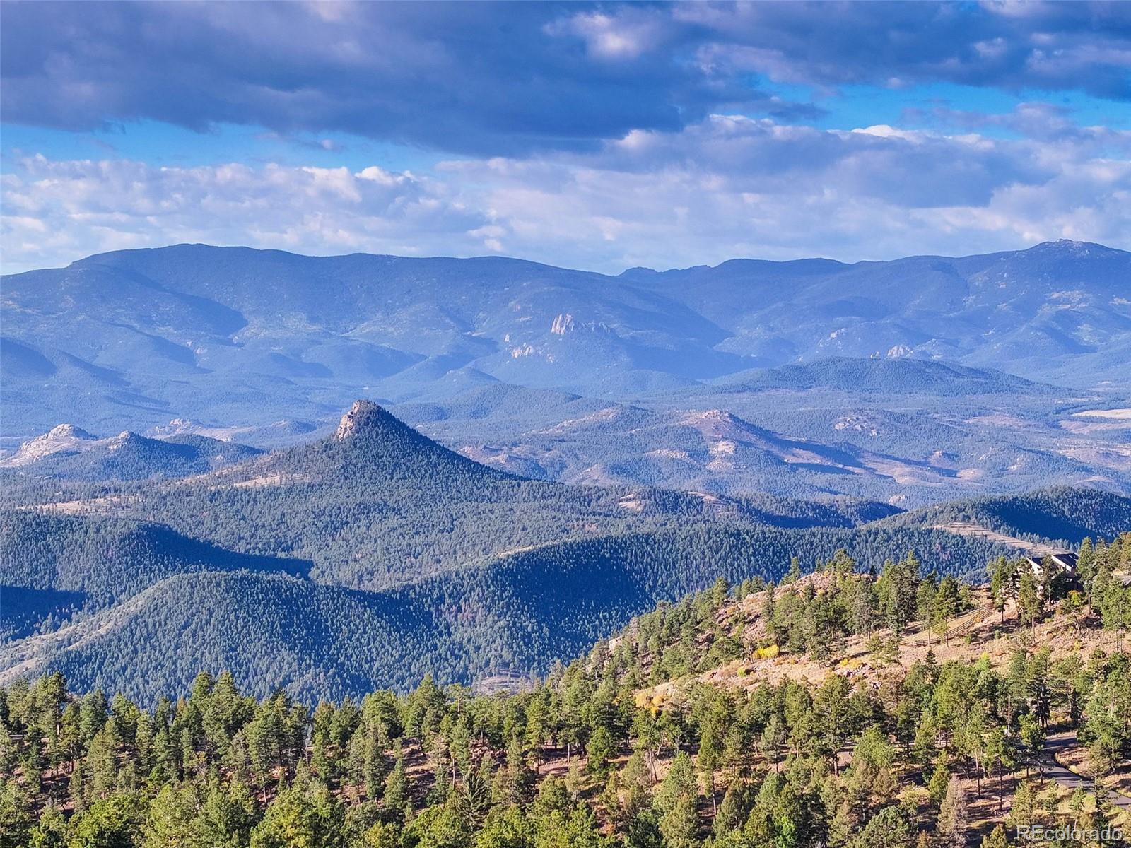 23047 Big Game Trail Conifer, CO 80433 - Photo 32 of 41 a view of a dry yard with wooden fence