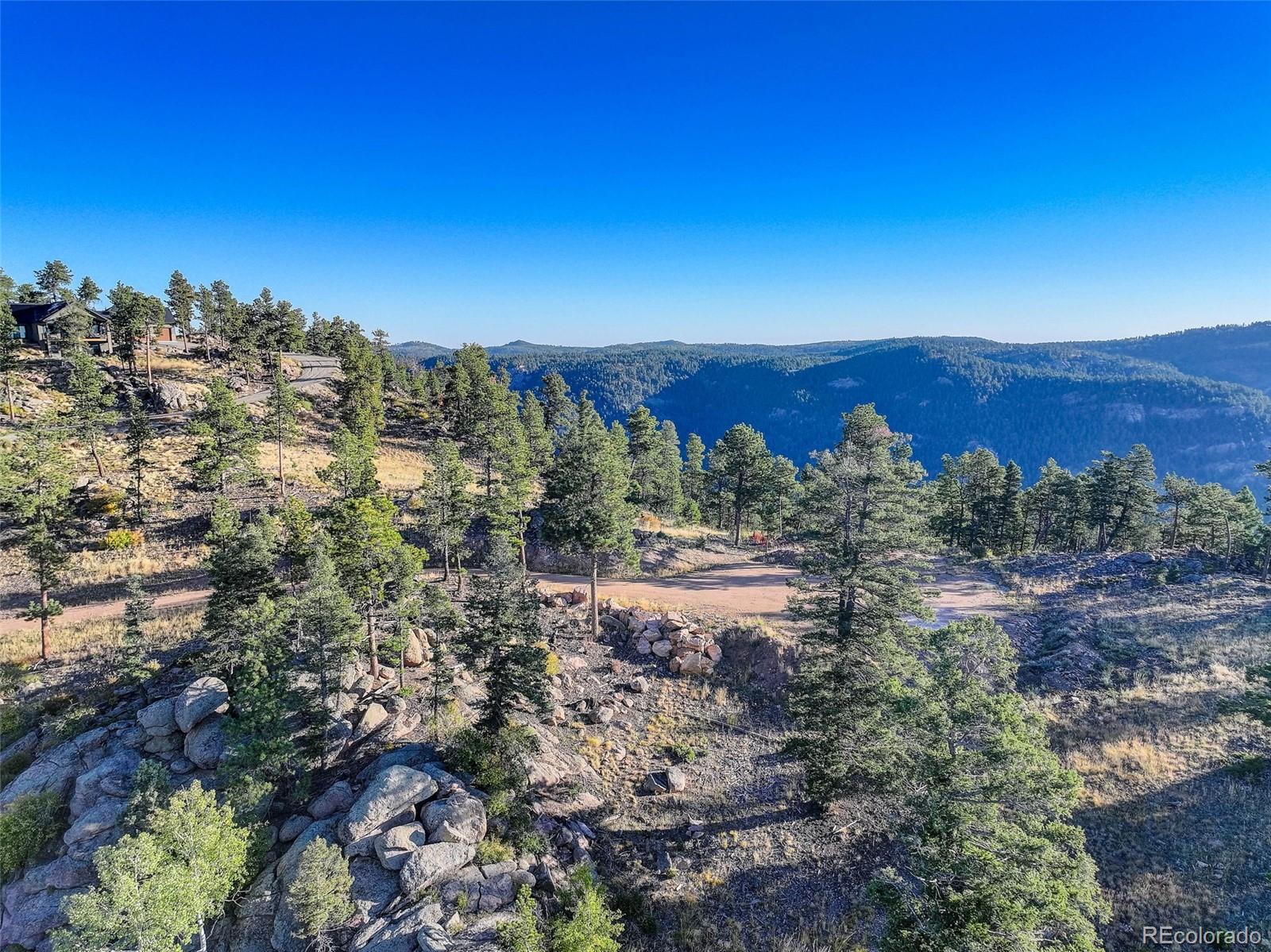 23047 Big Game Trail Conifer, CO 80433 - Photo 8 of 41 a view of a lake with mountains in the background