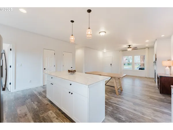 a view of kitchen with center island and wooden floor