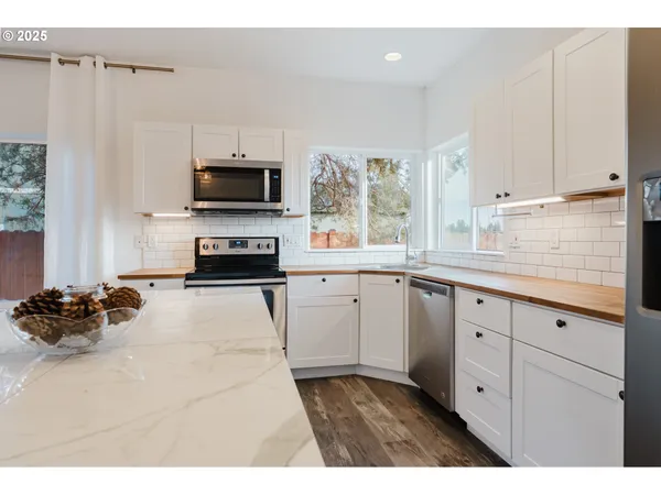 a kitchen with a refrigerator and a stove