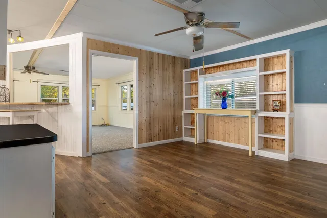 a view of a kitchen with wooden floor and a kitchen