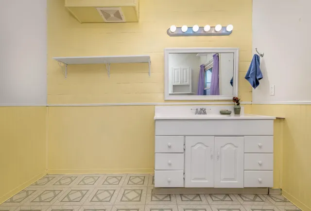 a bathroom with a sink and a mirror