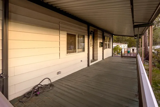 a view of a porch with wooden floor