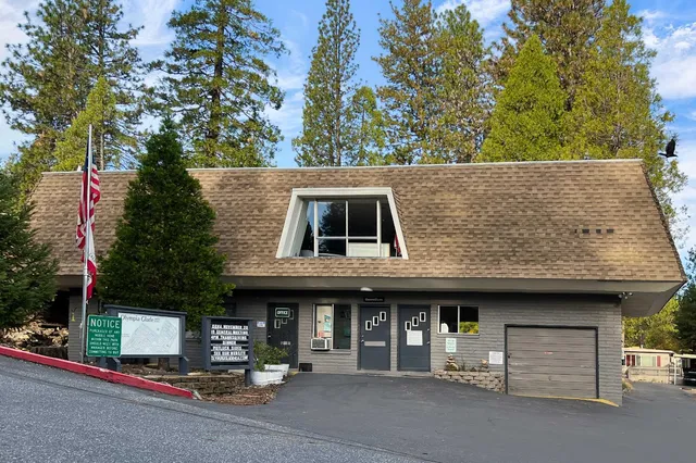 a view of a swimming pool with a yard and seating area