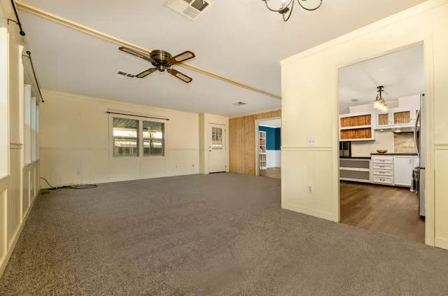 a view of a livingroom with furniture and a ceiling fan