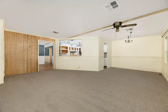 a view of a big room with closet and windows
