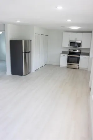 a view of kitchen and refrigerator