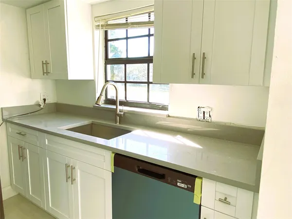 a kitchen with a sink and a window