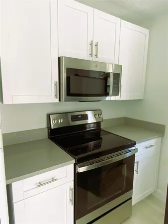 a kitchen with a stove and a microwave