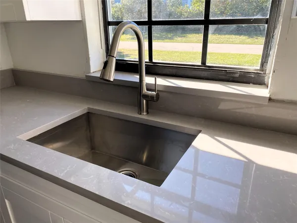 a kitchen with stainless steel appliances a refrigerator stove and sink