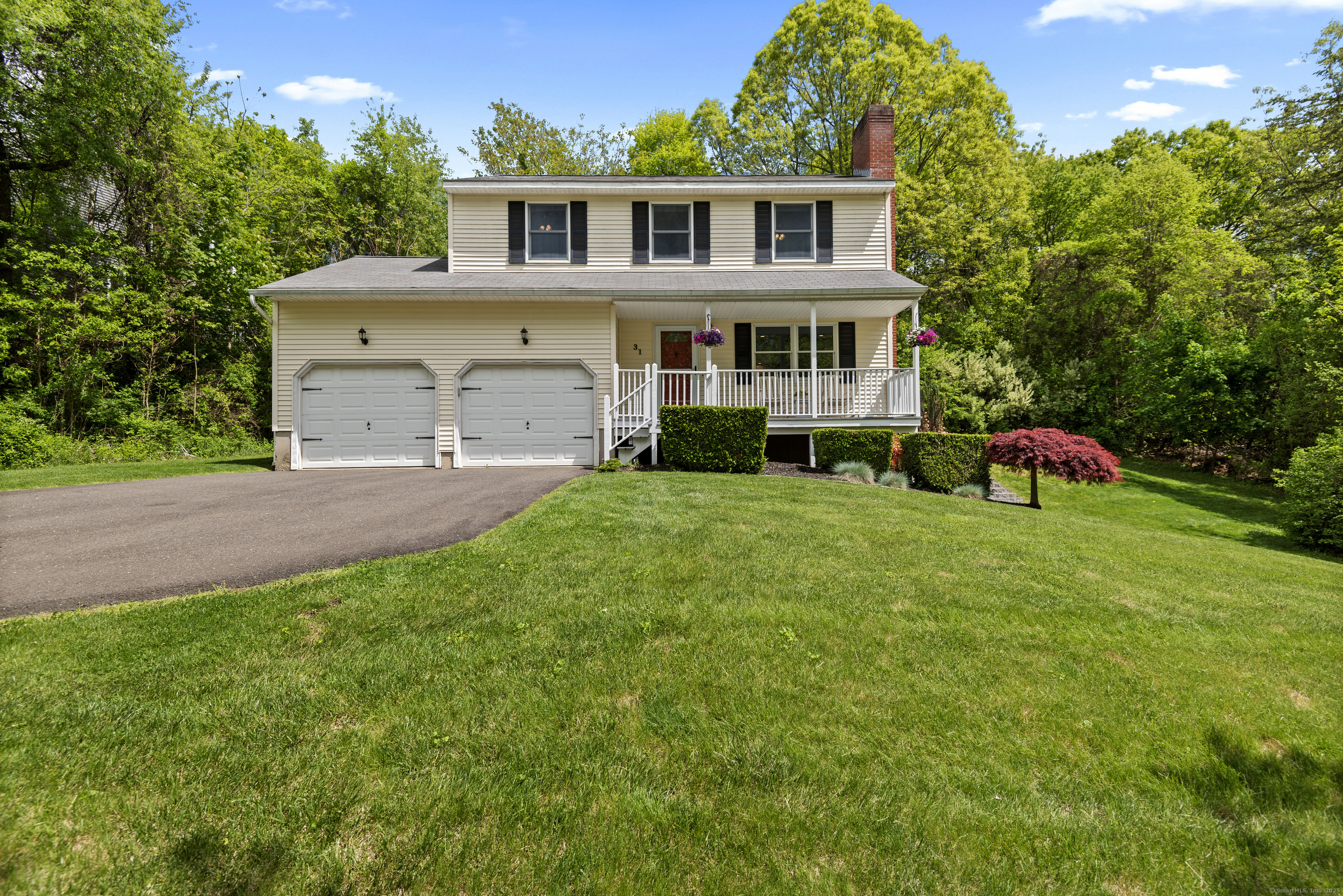 a front view of a house with a garden and plants