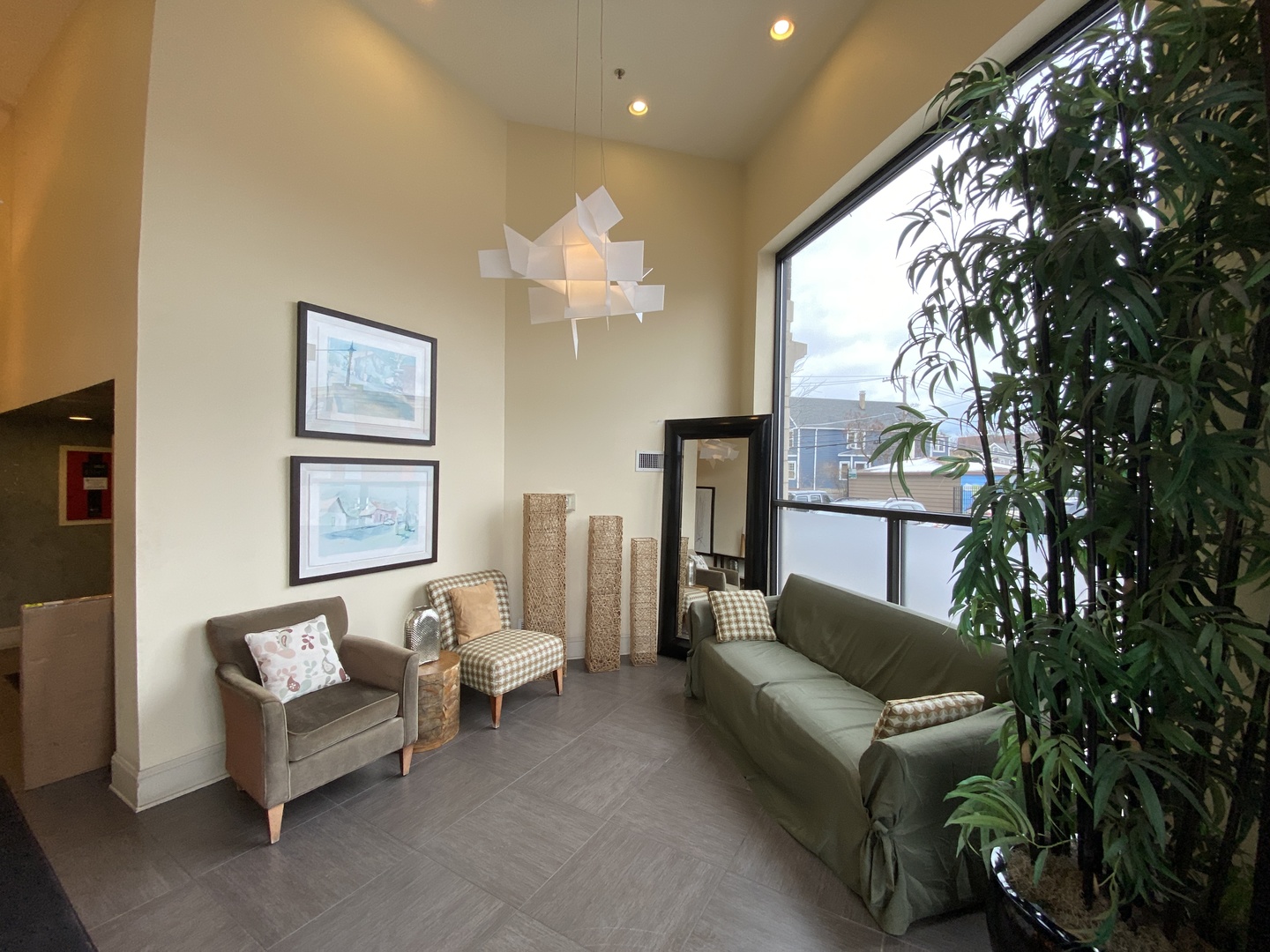 3300 West Irving Park Road, Unit H5 Chicago, IL 60618 - Photo 2 of 21 a living room with furniture and a chandelier