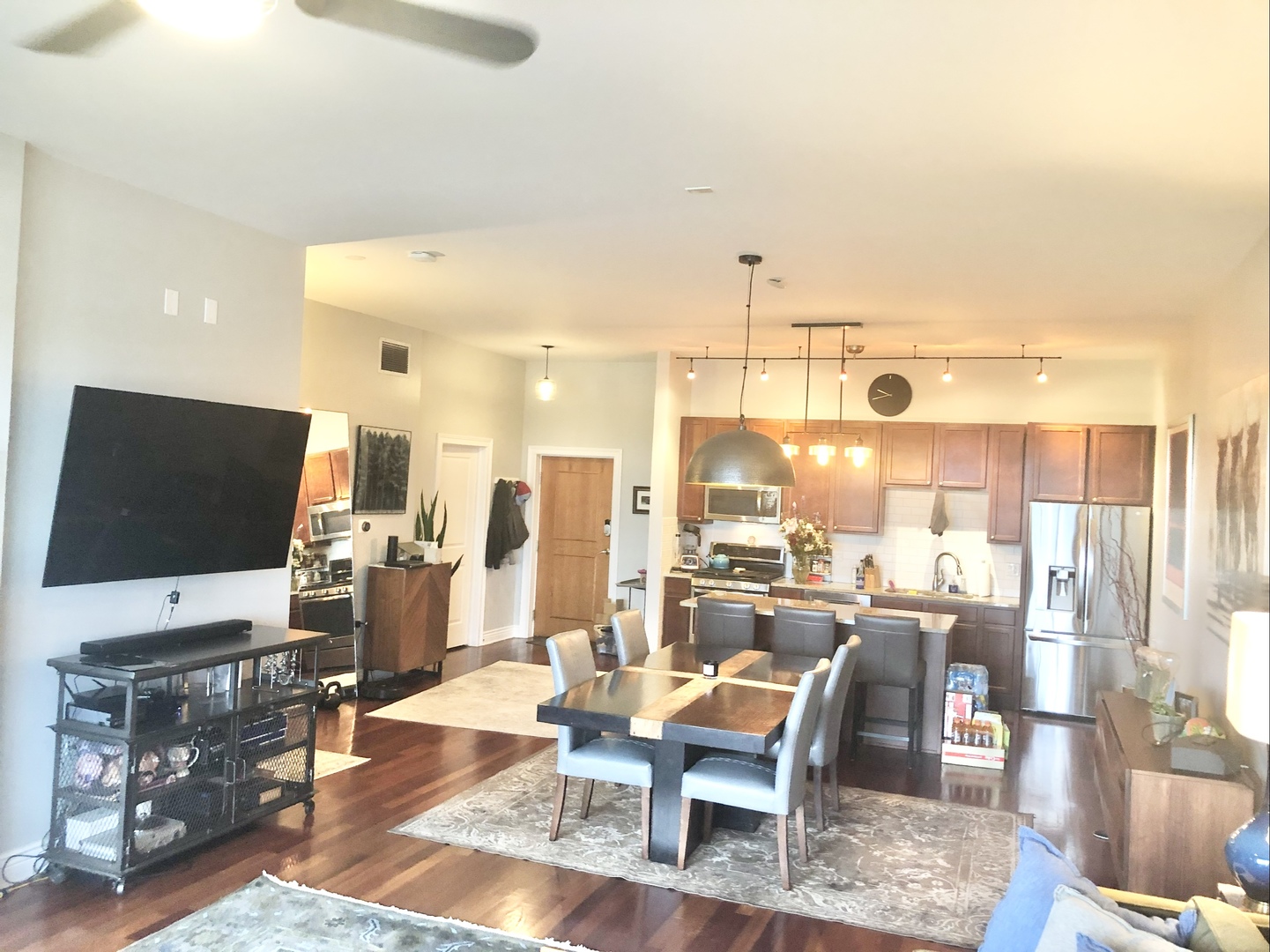 3300 West Irving Park Road, Unit H5 Chicago, IL 60618 - Photo 10 of 21 a living room with lots of furniture and a flat screen tv
