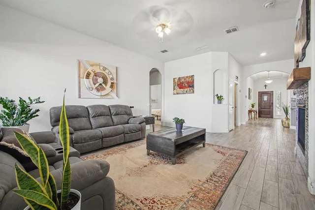 a living room with furniture and wooden floor