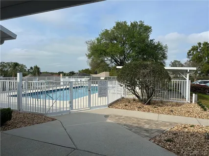 a view of swimming pool with outdoor seating and plants