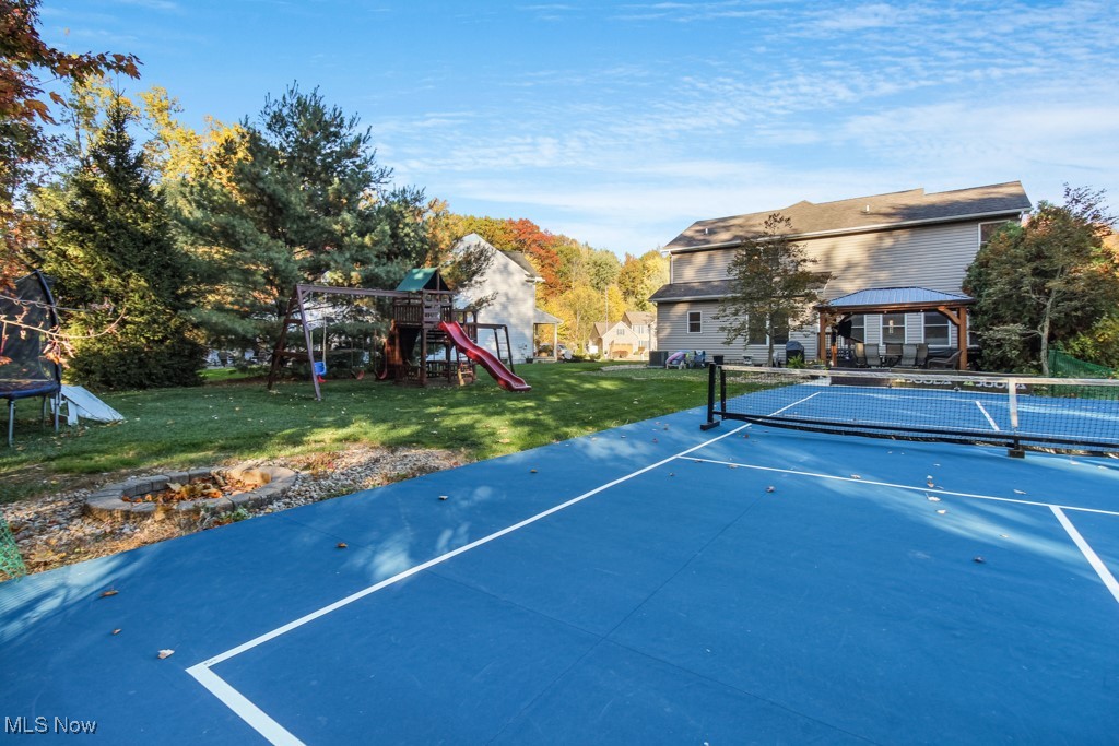 132 Timber Ridge Drive, Unit RDR Elyria, OH 44035 - Photo 40 of 41 View of sport court with a gazebo, a playground, a yard, and tennis court