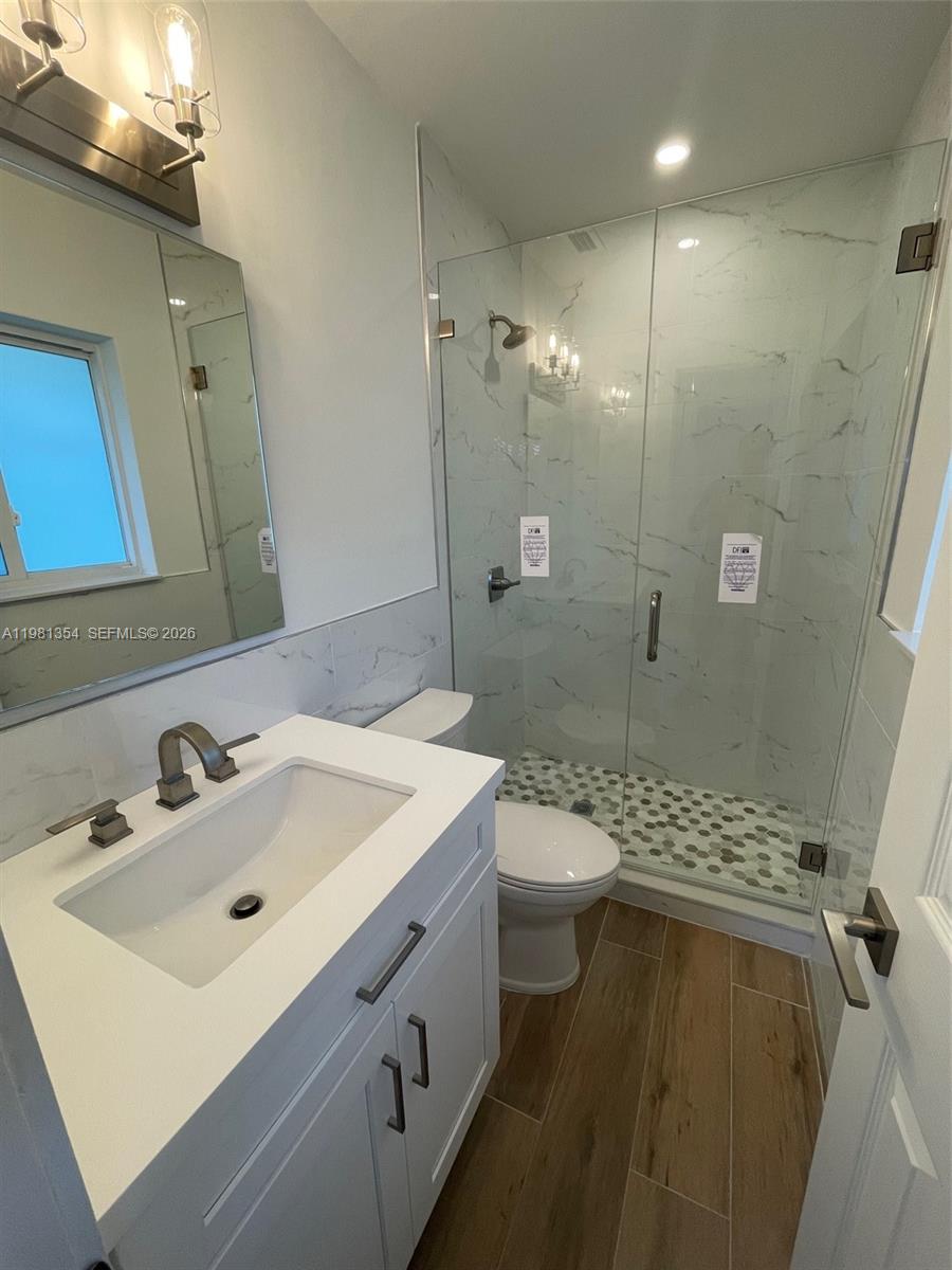 10343 Southwest 114th Street Miami, FL 33176 - Photo 11 of 25 a bathroom with a sink a toilet a mirror and shower