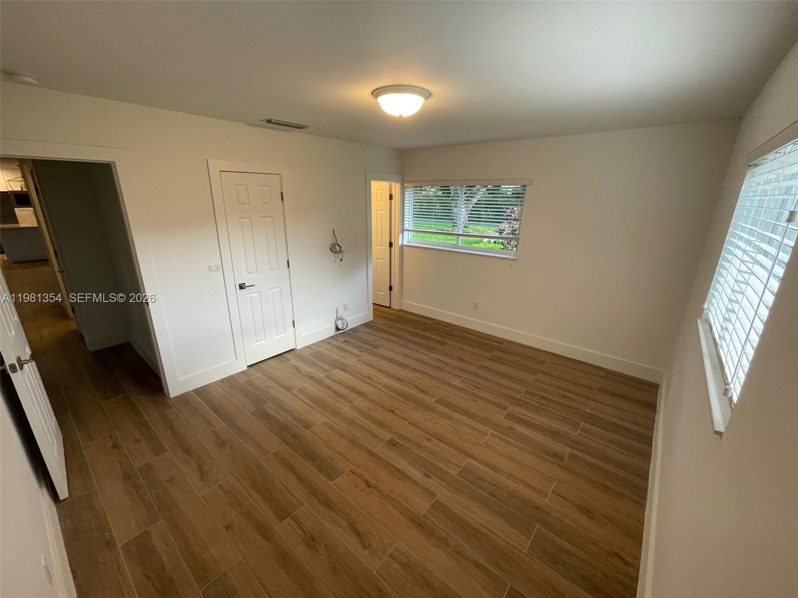 10343 Southwest 114th Street Miami, FL 33176 - Photo 16 of 25 wooden floor in an empty room with a window
