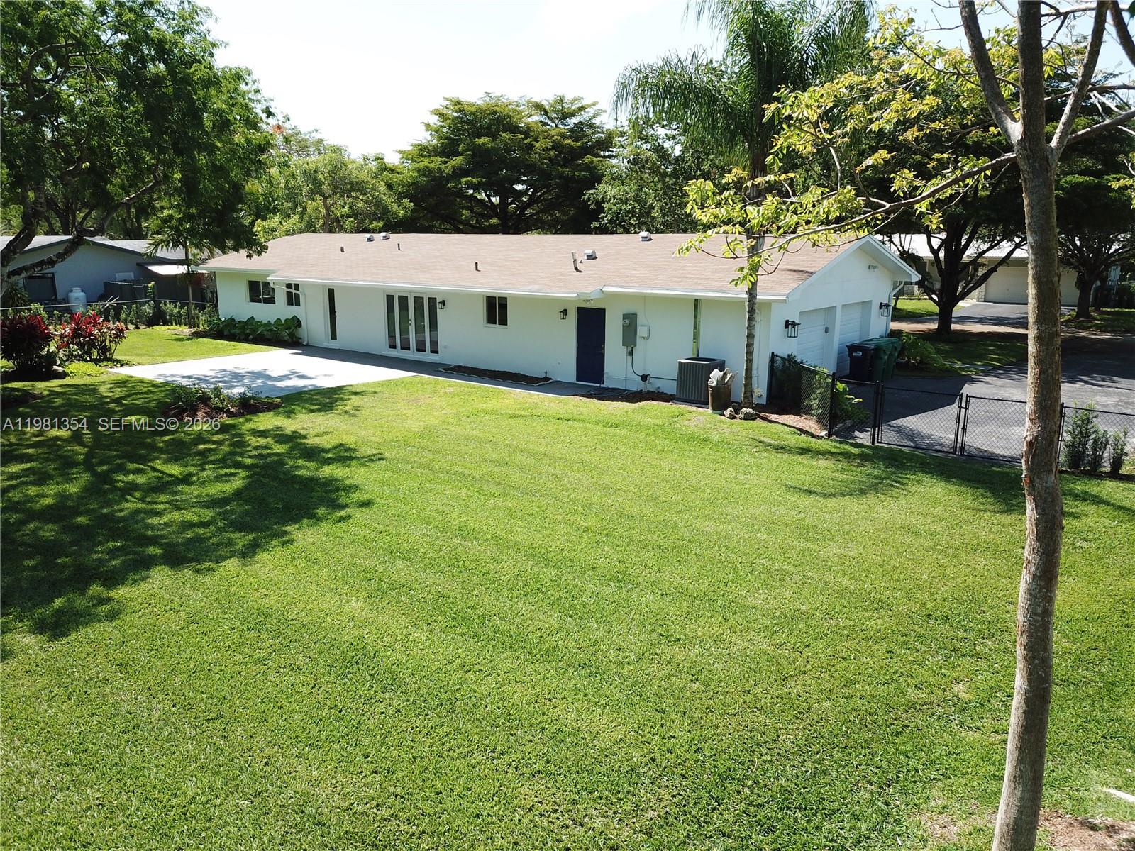 10343 Southwest 114th Street Miami, FL 33176 - Photo 18 of 25 a front view of a house with garden