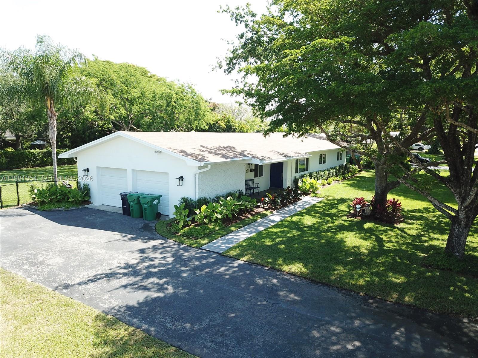 10343 Southwest 114th Street Miami, FL 33176 - Photo 19 of 25 a aerial view of a house with yard and green space