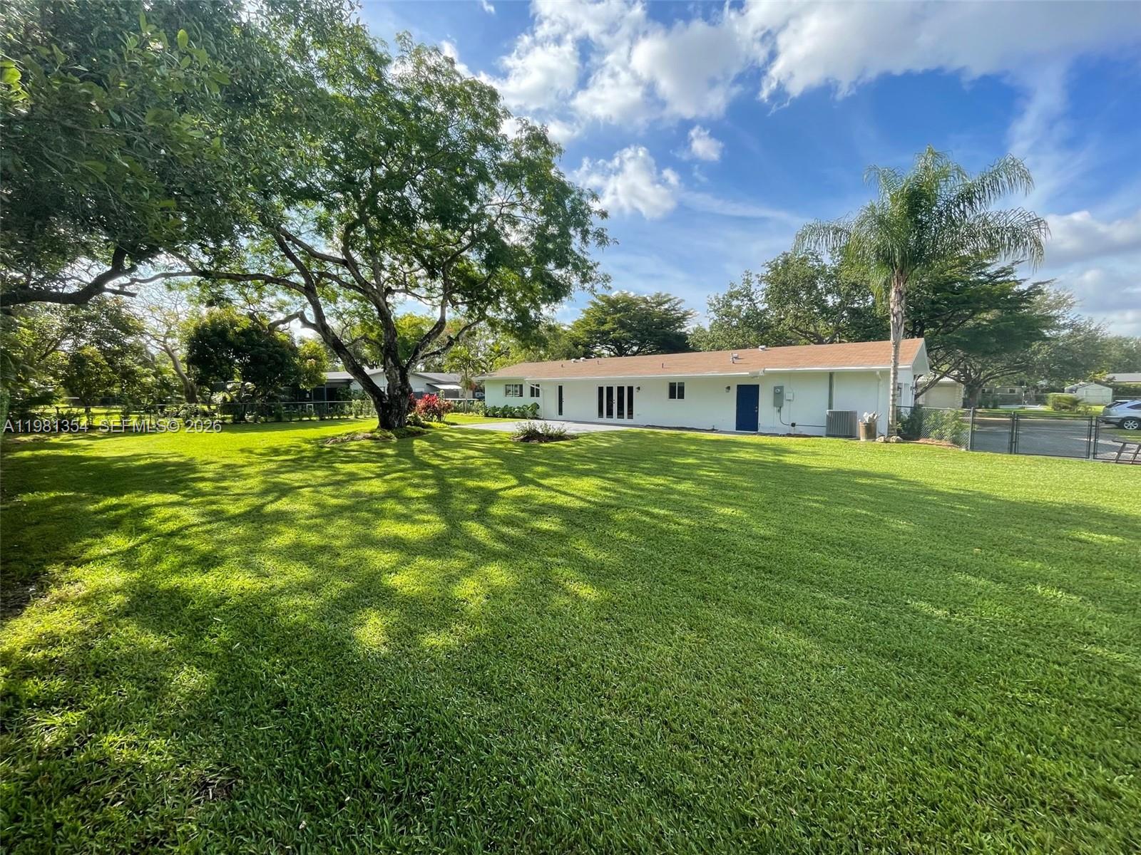 10343 Southwest 114th Street Miami, FL 33176 - Photo 20 of 25 a house view with swimming pool and green space