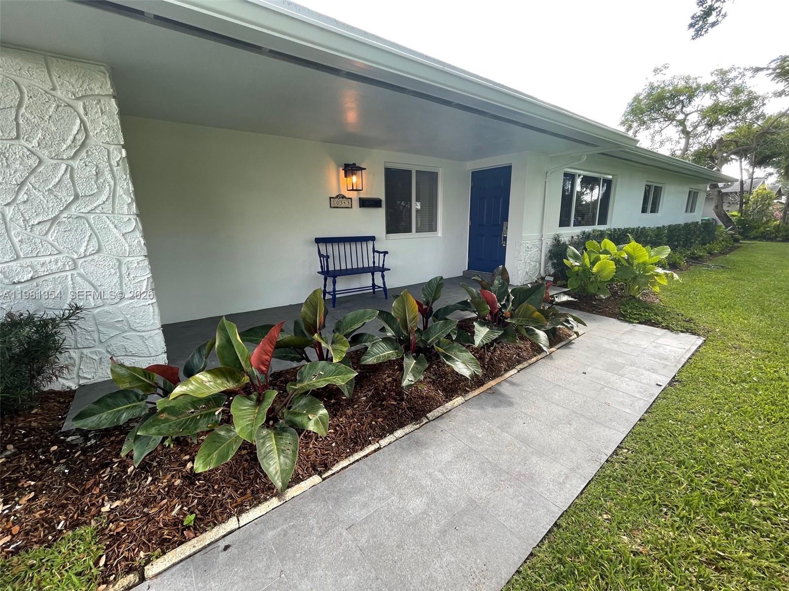 10343 Southwest 114th Street Miami, FL 33176 - Photo 2 of 25 a front view of a house with a yard