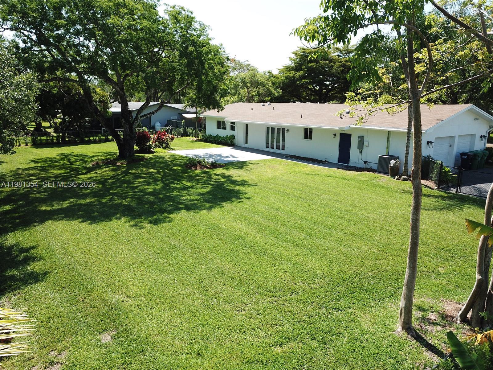 10343 Southwest 114th Street Miami, FL 33176 - Photo 23 of 25 a house view with a sitting space and garden