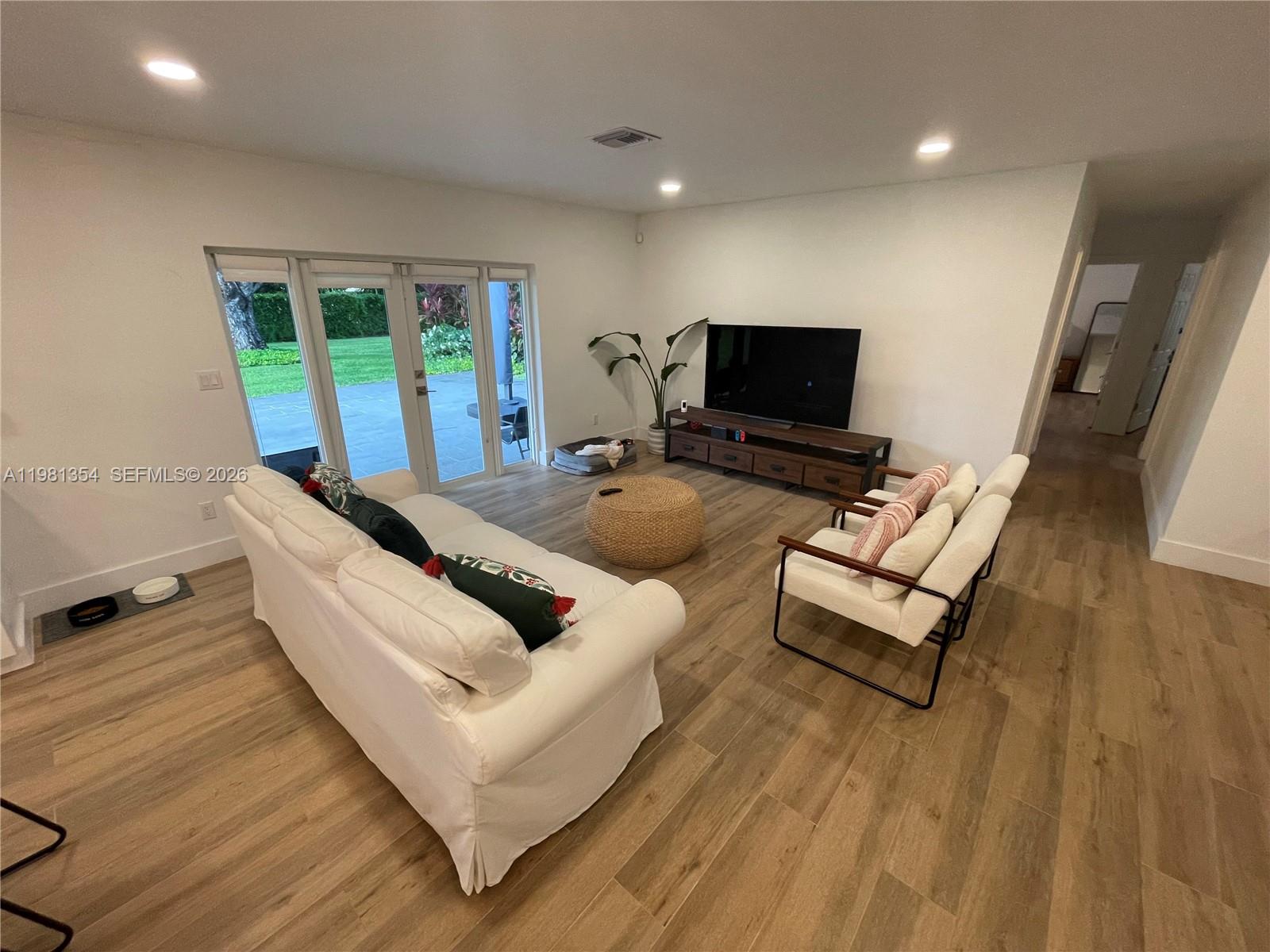 10343 Southwest 114th Street Miami, FL 33176 - Photo 3 of 25 a living room with furniture and a flat screen tv