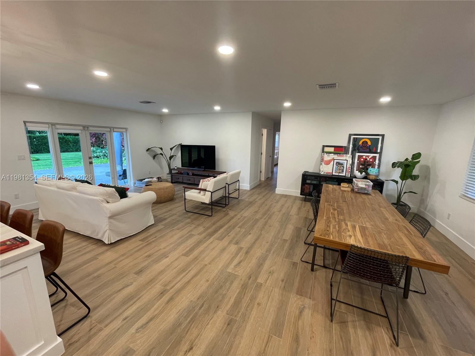 10343 Southwest 114th Street Miami, FL 33176 - Photo 4 of 25 a living room with furniture and a wooden floor