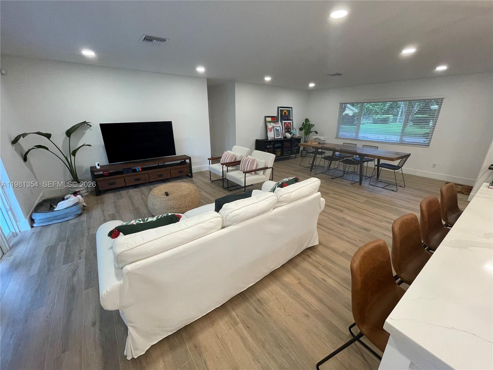 10343 Southwest 114th Street Miami, FL 33176 - Photo 5 of 25 a living room with furniture and a flat screen tv