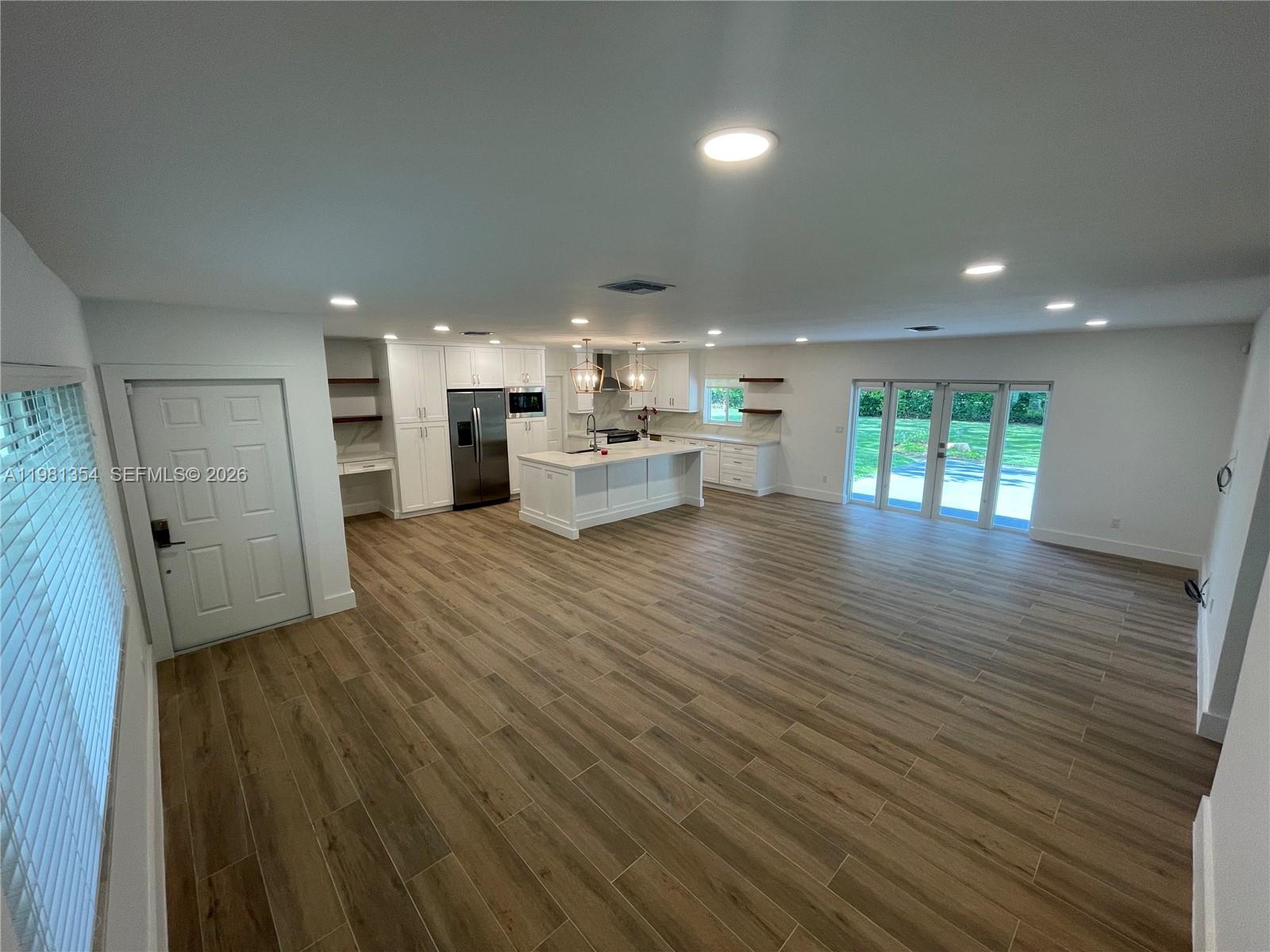 10343 Southwest 114th Street Miami, FL 33176 - Photo 9 of 25 a living room with furniture and a wooden floor