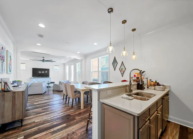 a kitchen with a sink a stove and chairs