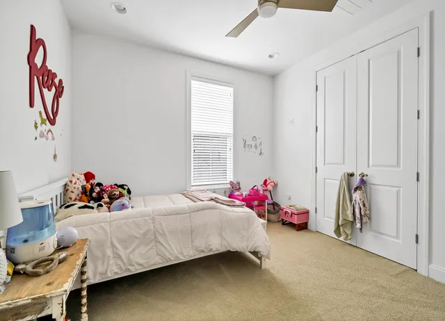 a bedroom with bed and a chandelier