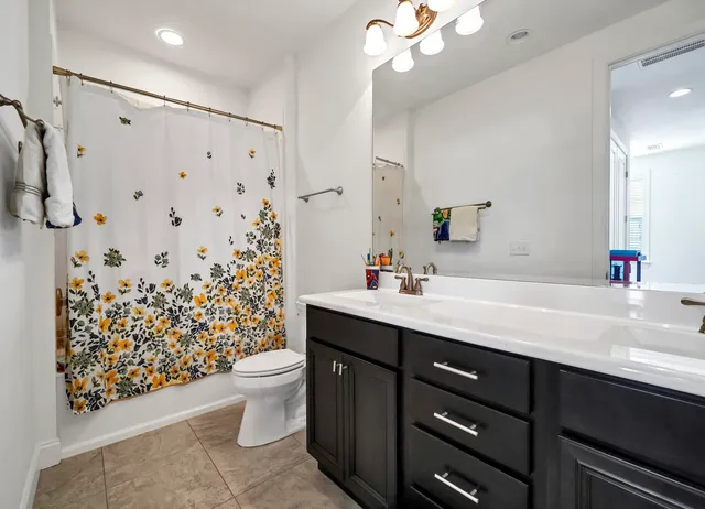 a bathroom with a sink vanity mirror and toilet
