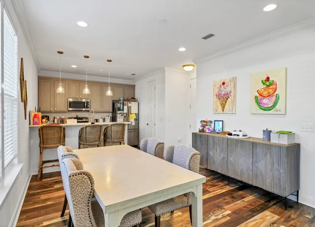 a living room with furniture and kitchen view