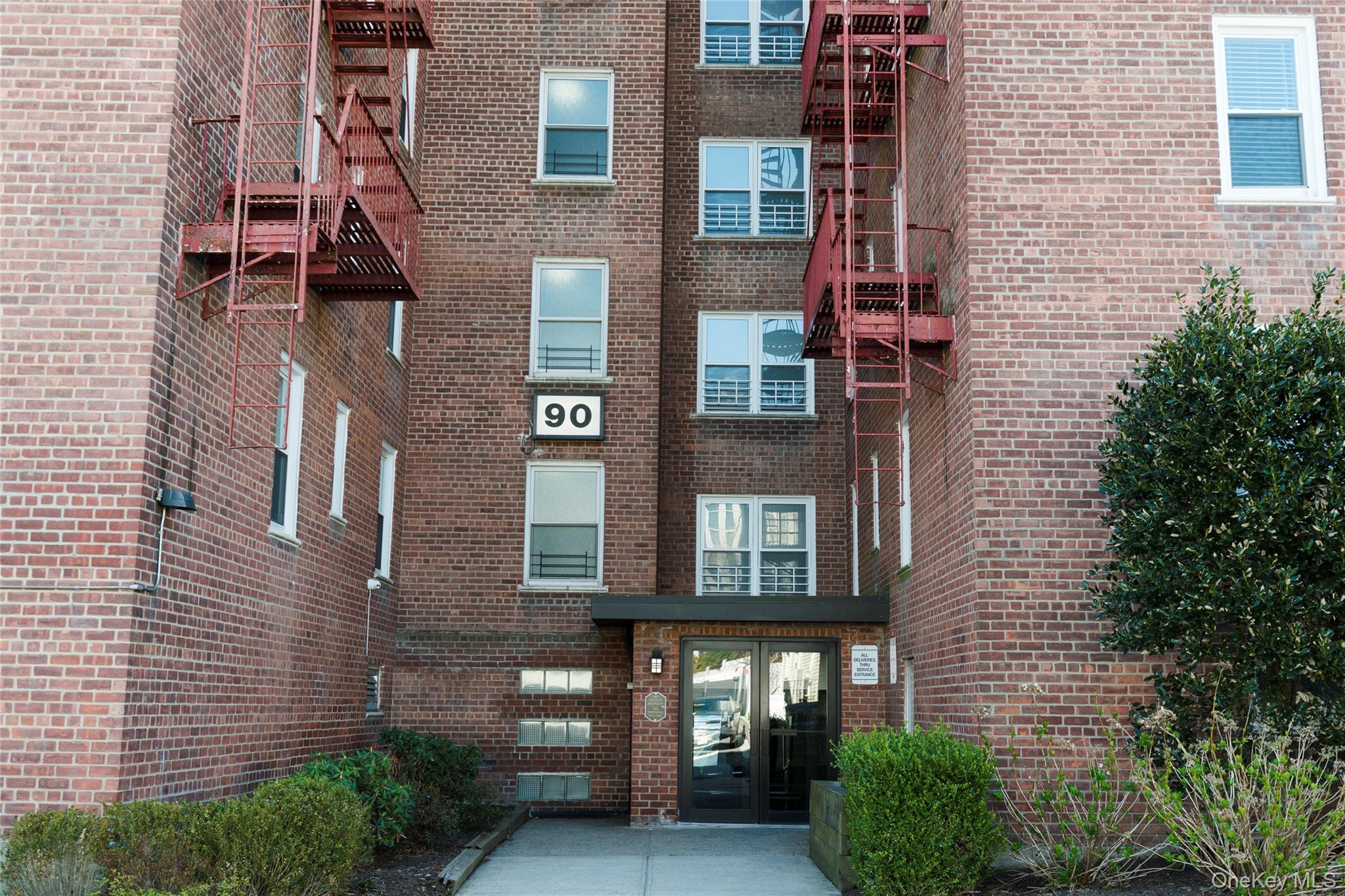 a view of a brick building next to a yard