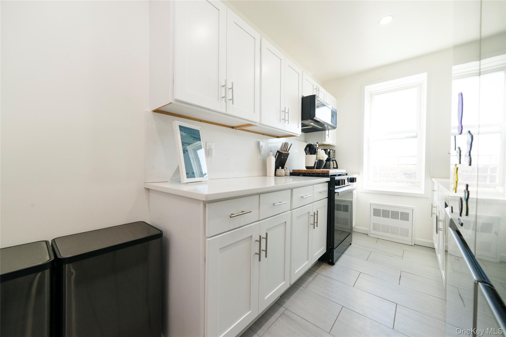 90 Union Street, Unit 5G New Rochelle, NY 10805 - Photo 6 of 18 a kitchen with white cabinets and appliances