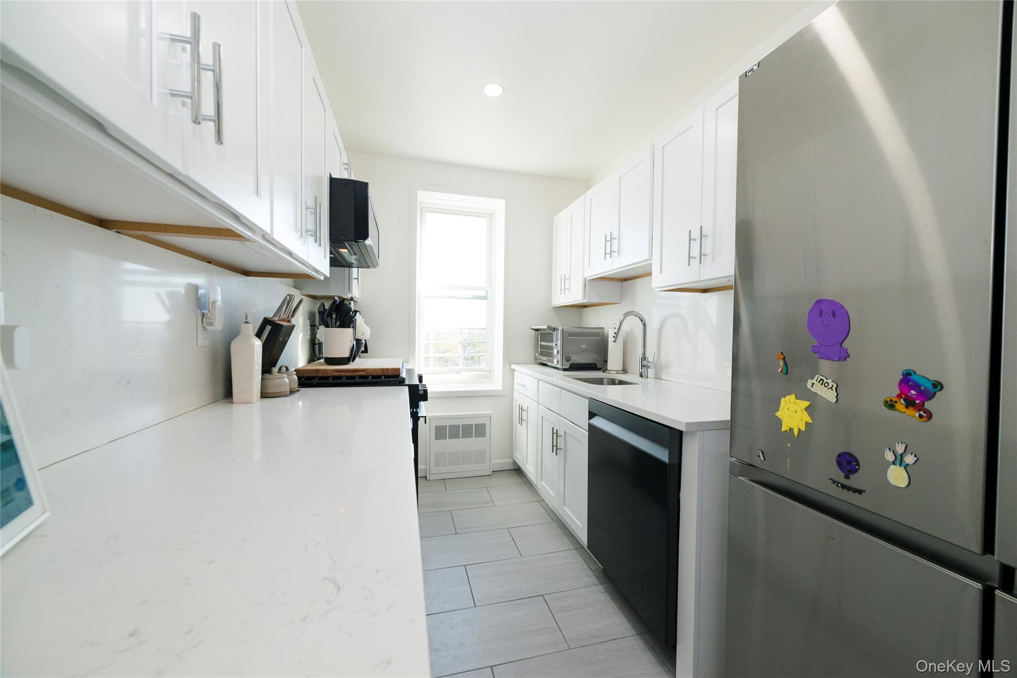 90 Union Street, Unit 5G New Rochelle, NY 10805 - Photo 8 of 18 a kitchen with refrigerator and cabinets