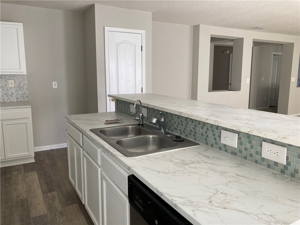 76222 Long Pond Loop Yulee, FL 32097 - Photo 3 of 6 a kitchen with stainless steel appliances granite countertop a sink and dishwasher with wooden floor