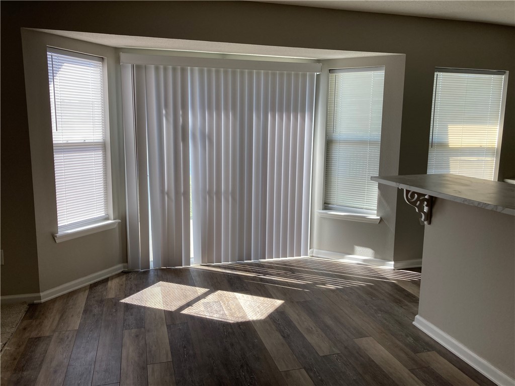 76222 Long Pond Loop Yulee, FL 32097 - Photo 5 of 6 an empty room with wooden floor and windows