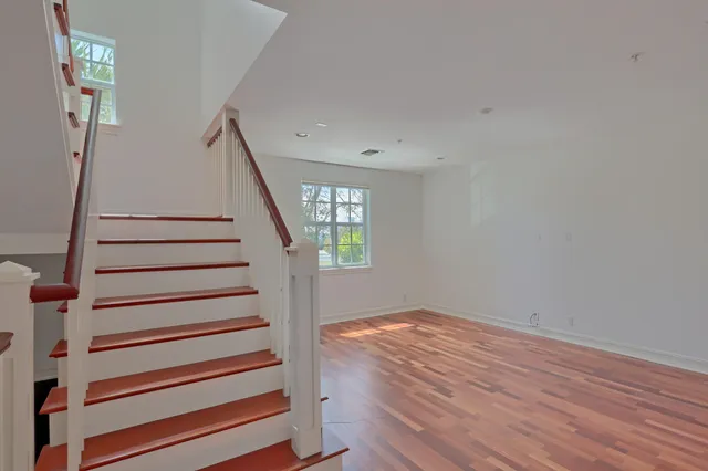 a view of hallway with wooden floor and stairs