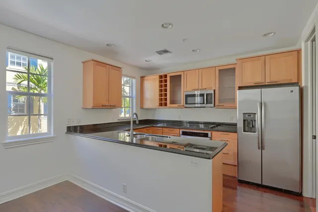 a kitchen with stainless steel appliances white cabinets and a sink