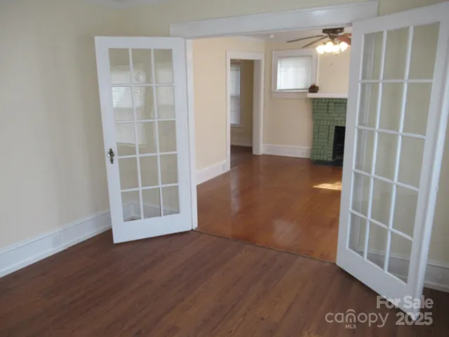 an empty room with wooden floor and a cabinet